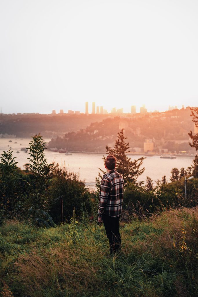 IELTS Speaking Part 2 place cue cards: a man looking over a city at sunset