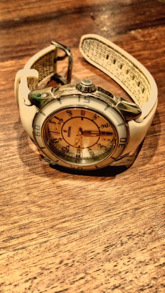 IELTS Speaking Part 2 possessions cue cards: a wristwatch on a wooden table