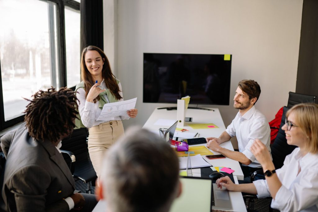 IELTS Speaking Part 2 work cue cards: colleagues discussing ideas in an office